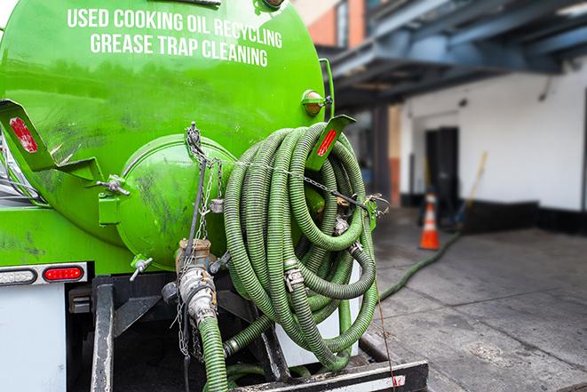 a service truck pumping grease from a restaurant's grease trap in Brighton, MA